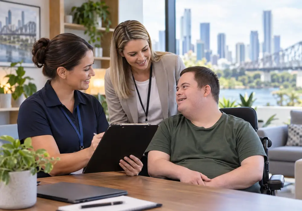 Two staff members showing a participant a tablet in a lounge room with a city view